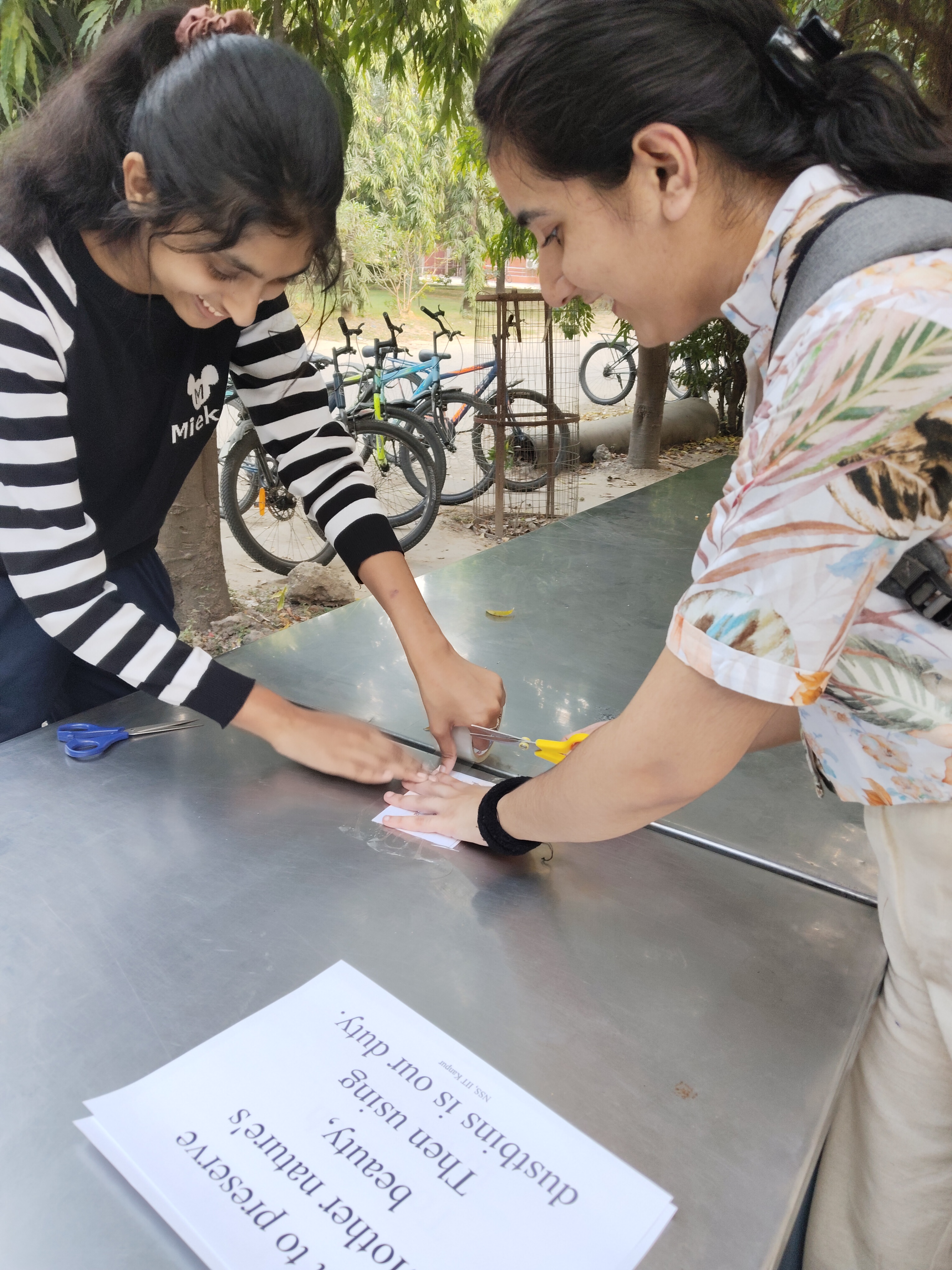NSS Volunteer placing a cleanliness poster